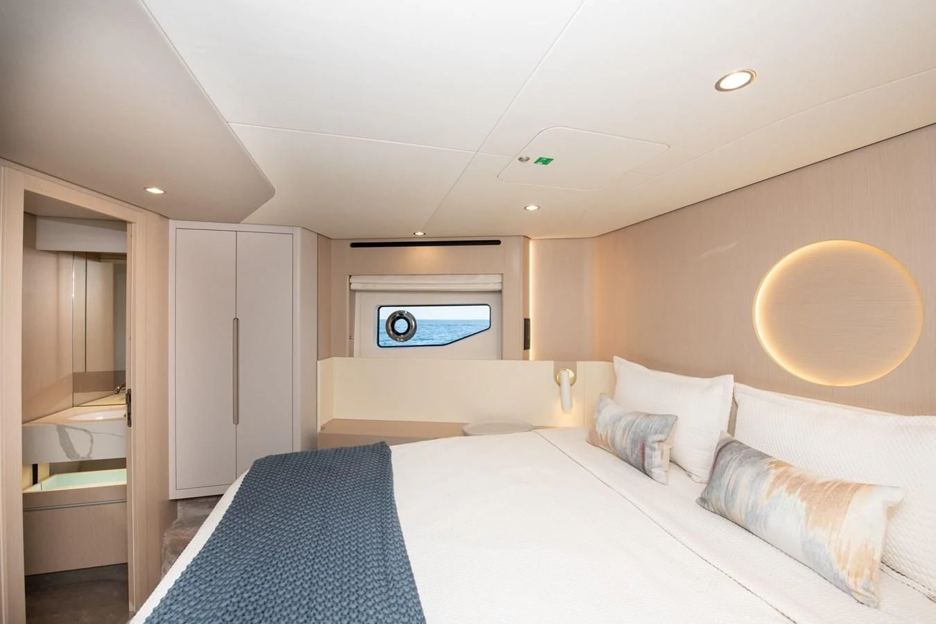 a bedroom with a bed and a tv on the wall aboard CRIMSON Yacht for Sale