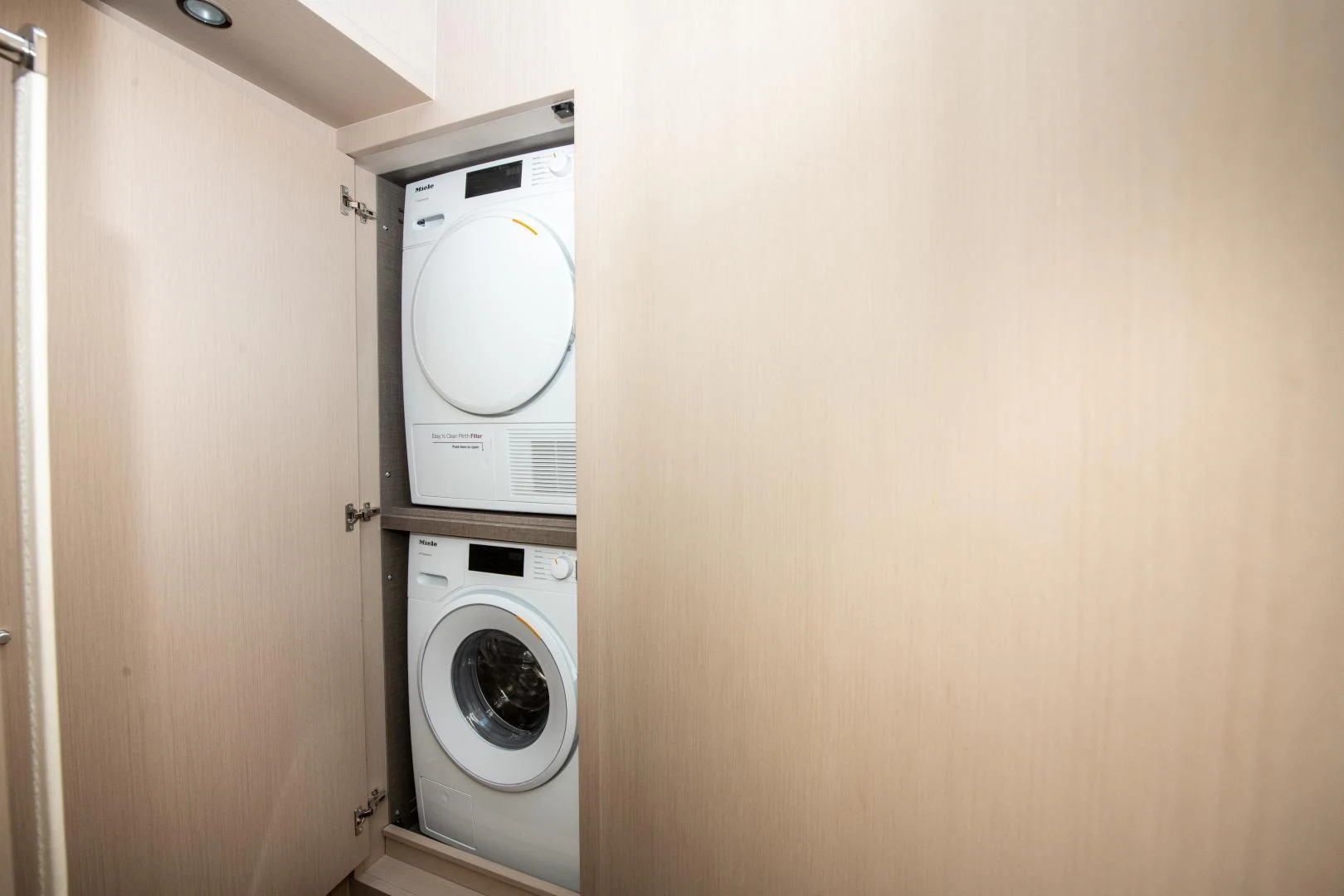 a closet with a washing machine and dryer aboard CRIMSON Yacht for Sale