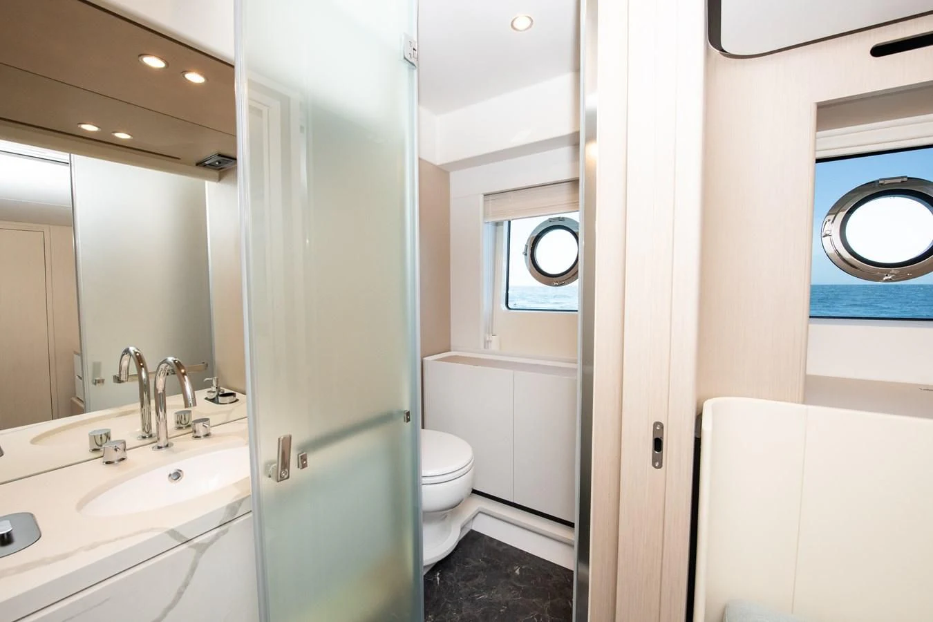 a bathroom with a glass shower aboard CRIMSON Yacht for Sale