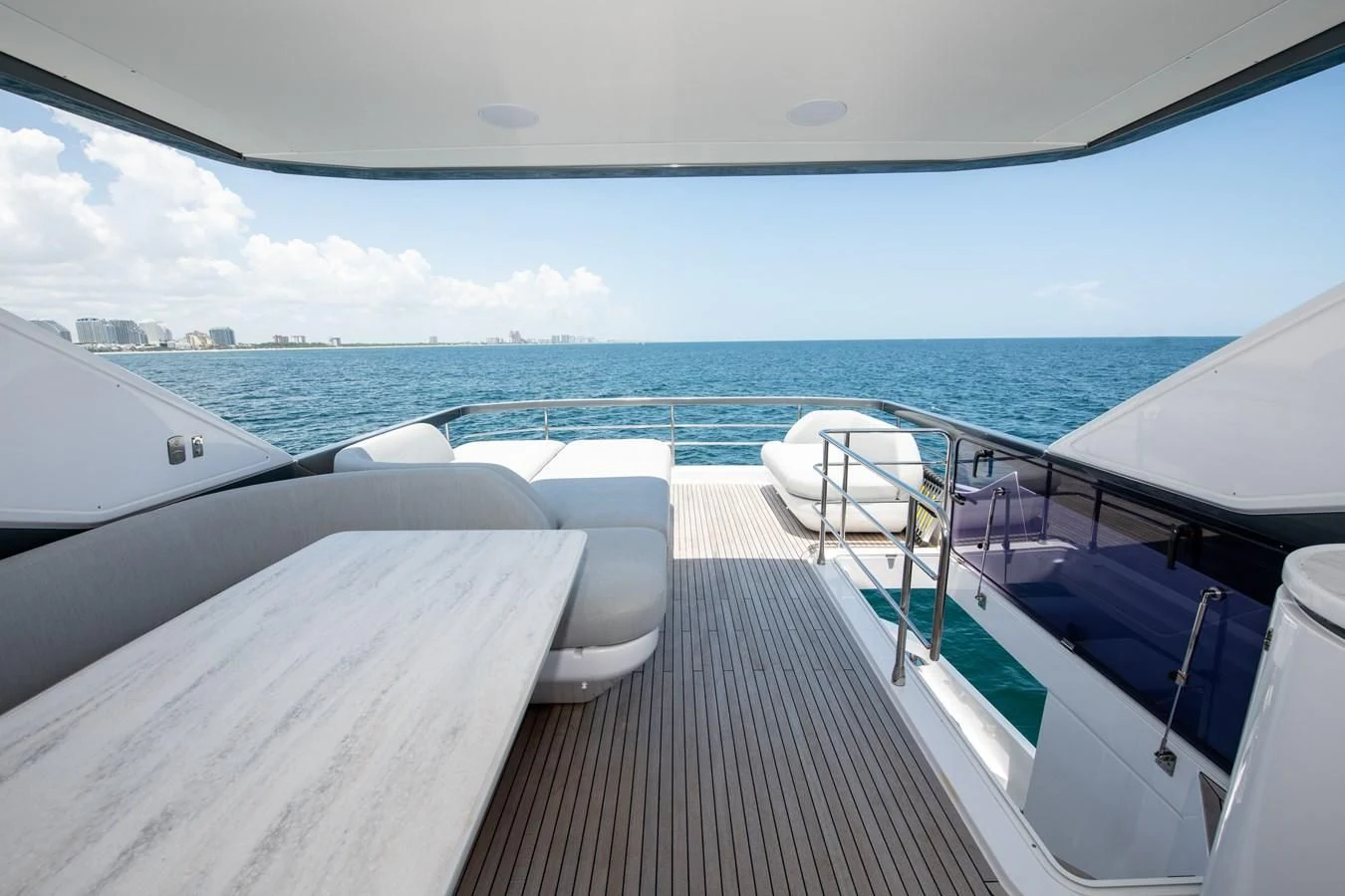 a deck with a view of the ocean and the city aboard CRIMSON Yacht for Sale