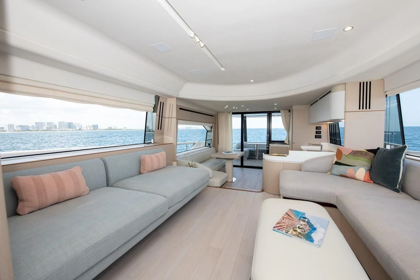 a living room with a large window aboard CRIMSON Yacht for Sale