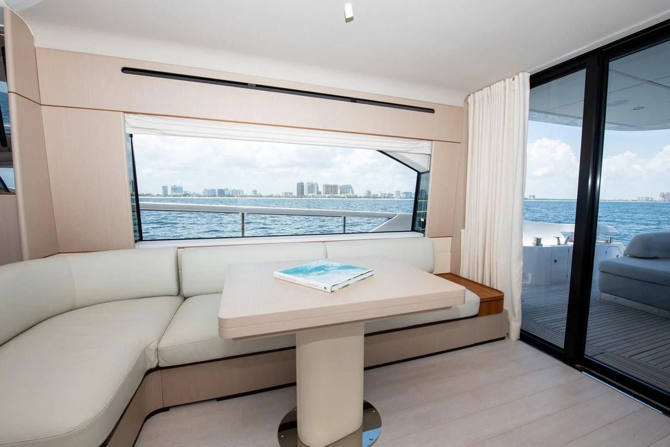 a room with a couch and a table and a window aboard CRIMSON Yacht for Sale