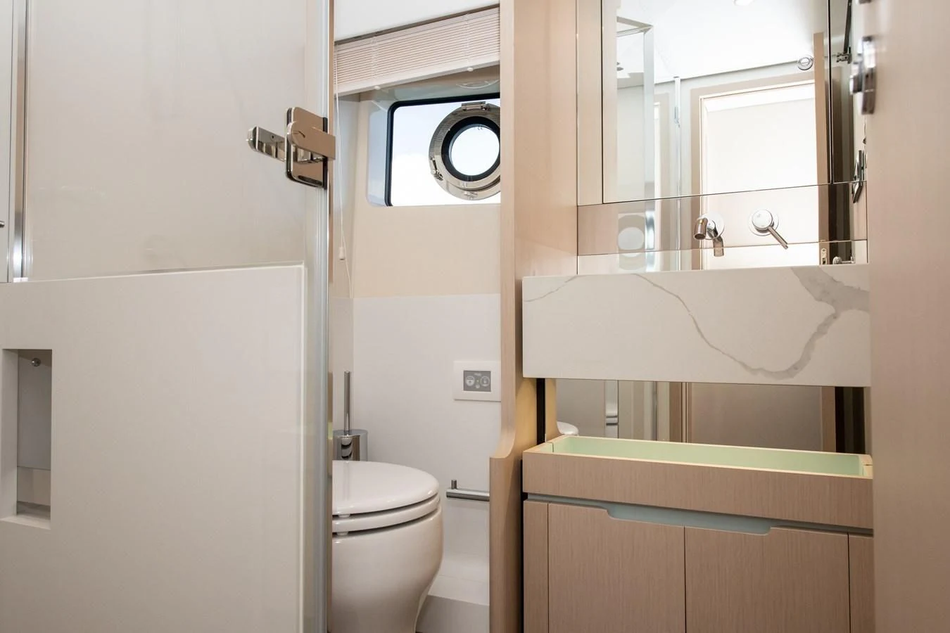 a bathroom with a toilet and a mirror aboard CRIMSON Yacht for Sale