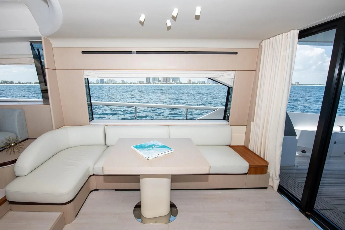 a living room with a large window aboard CRIMSON Yacht for Sale