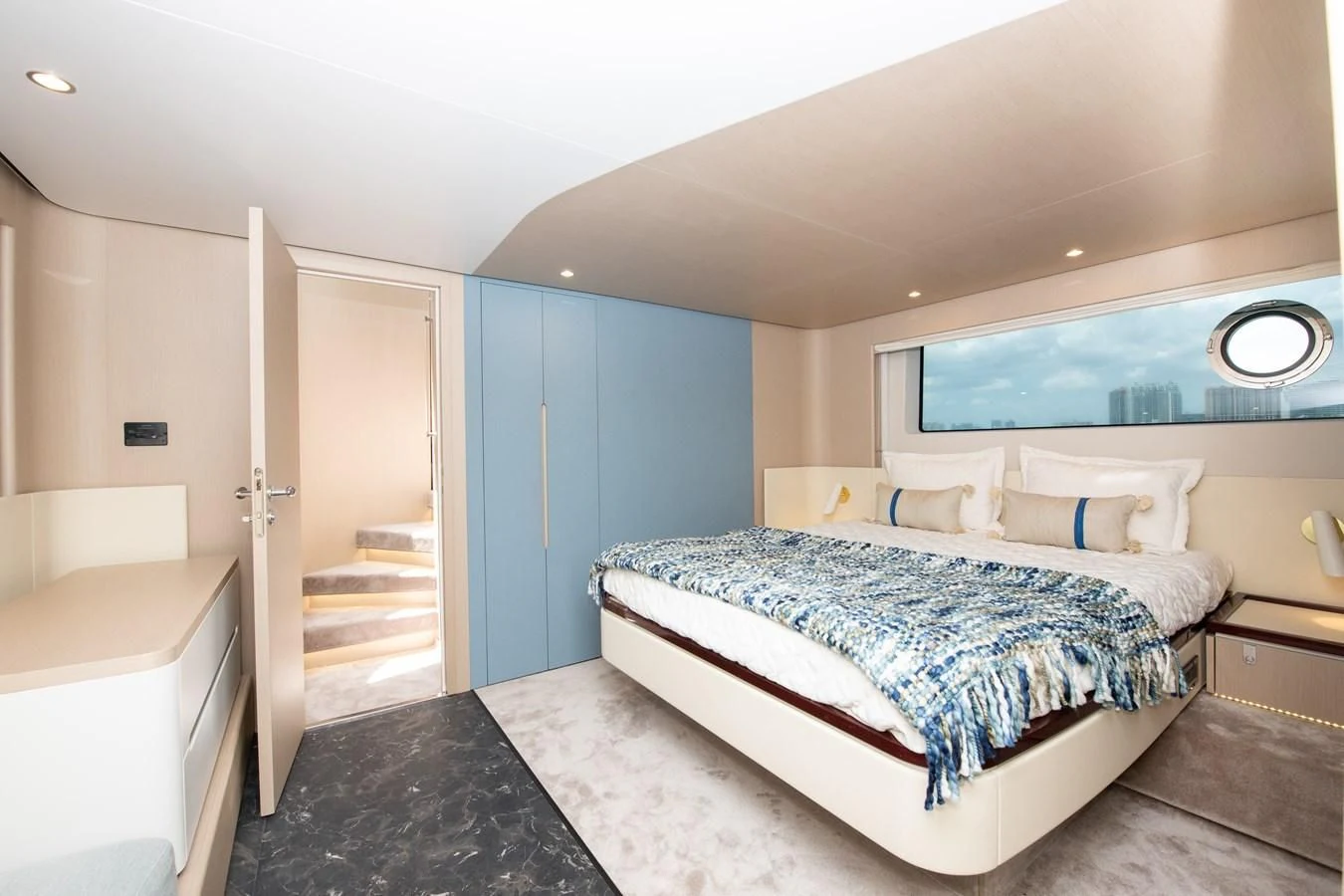 a bedroom with a bed and a mirror aboard CRIMSON Yacht for Sale