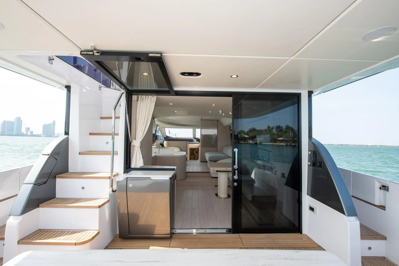 a room with a view of the city and water aboard CRIMSON Yacht for Sale