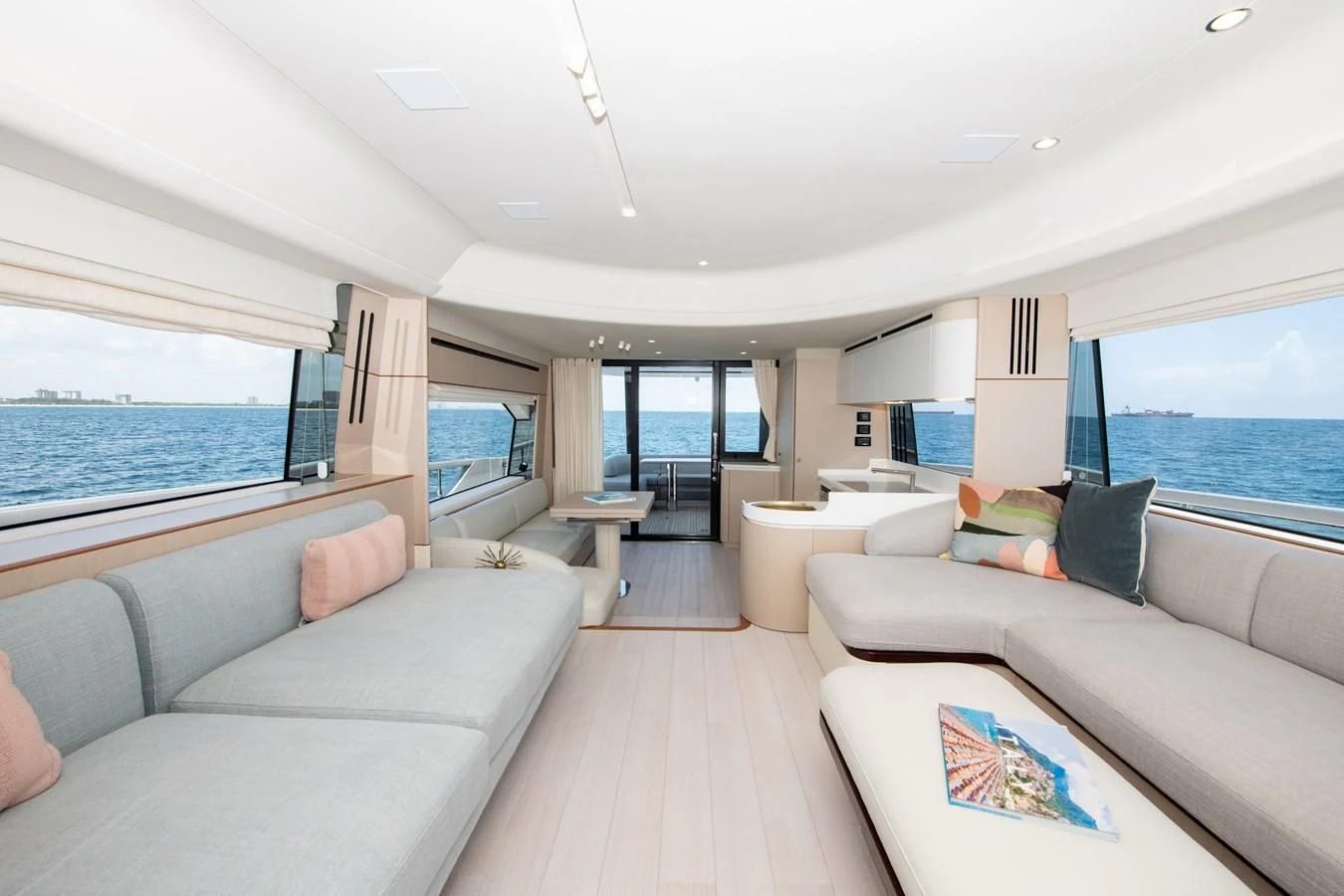 a living room with a large window aboard CRIMSON Yacht for Sale