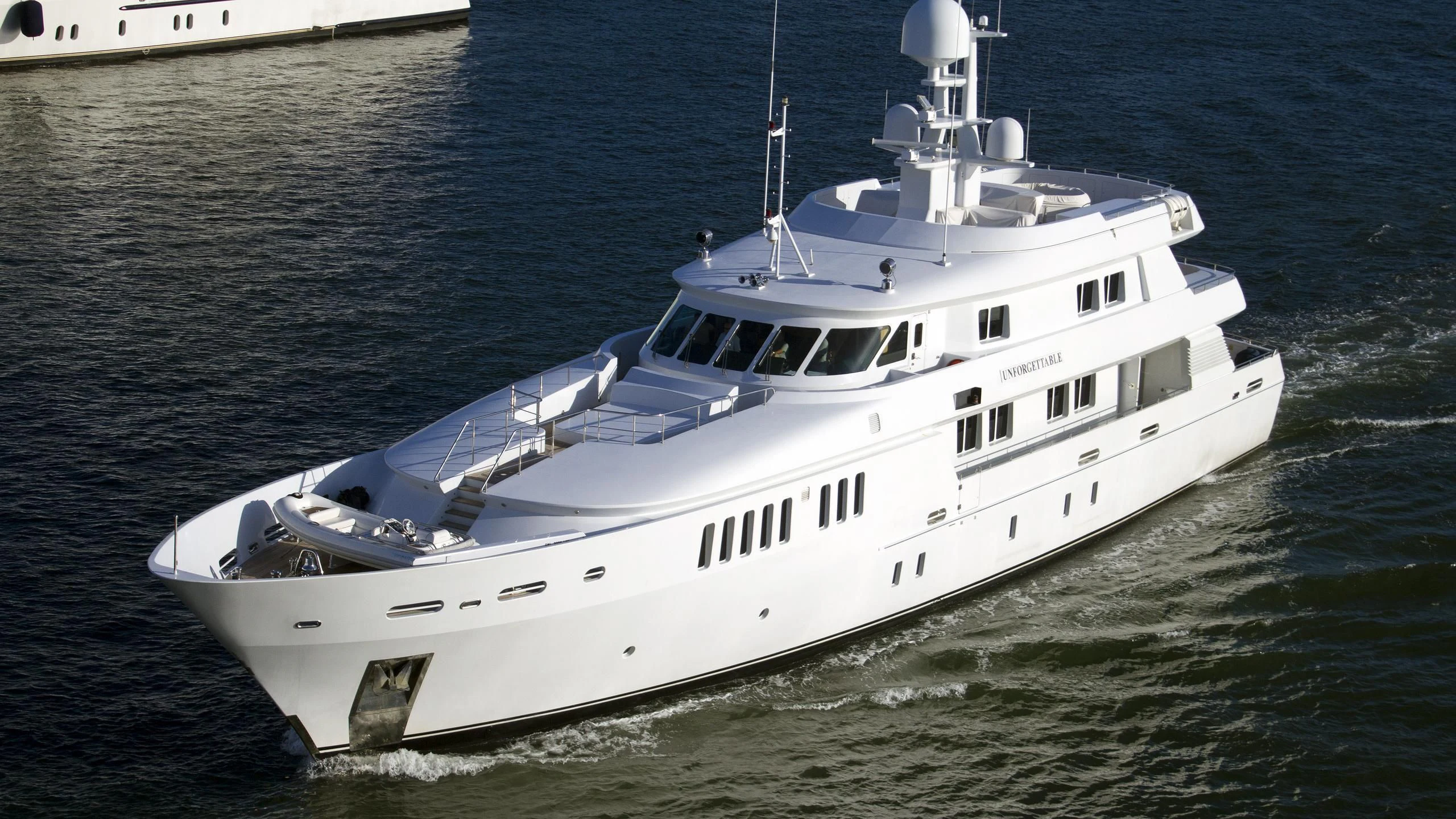 a white boat on the water aboard UNFORGETTABLE Yacht for Sale