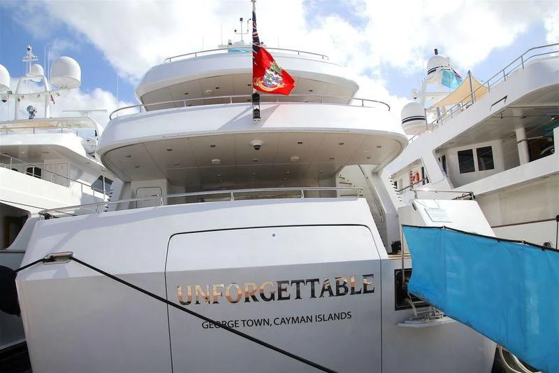 a boat with a flag on the front aboard UNFORGETTABLE Yacht for Sale