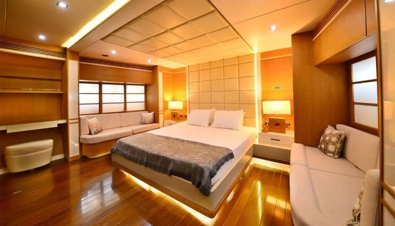 a large bedroom with a bed and a couch aboard ZELDA Yacht for Sale