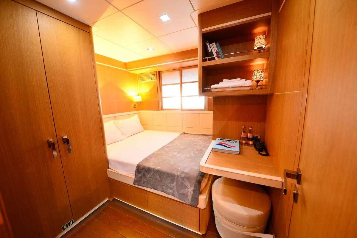 a room with a bed and a desk aboard ZELDA Yacht for Sale