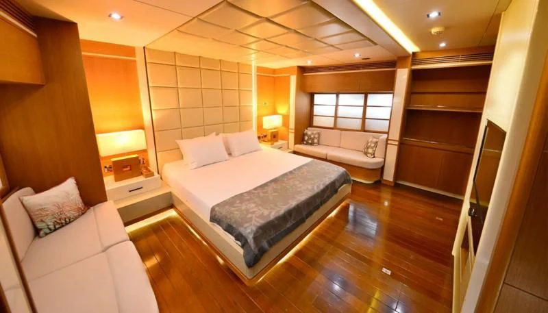 a room with a bed and a table aboard ZELDA Yacht for Sale