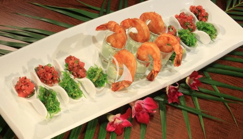 a plate of shrimp and vegetables aboard ZELDA Yacht for Sale