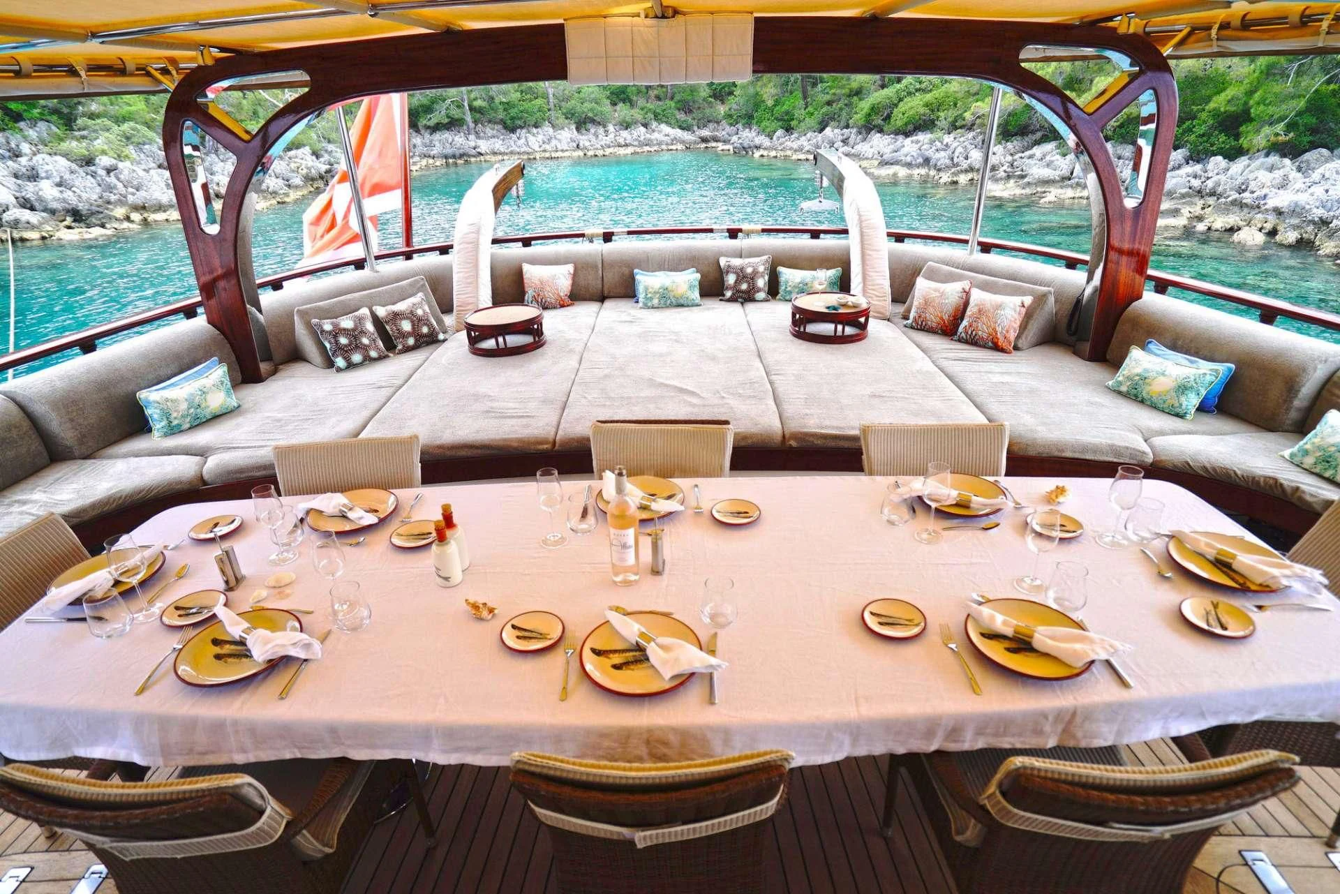 a table with plates and chairs on it aboard ZELDA Yacht for Sale