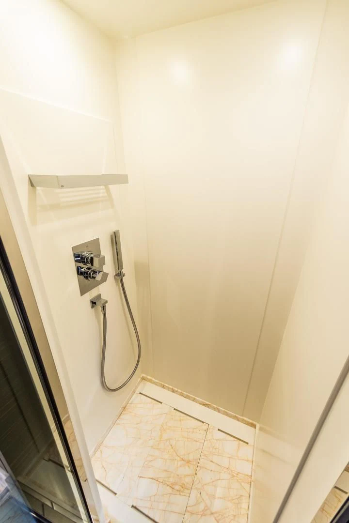 a white wall with a metal handle aboard BLUE BAY Yacht for Sale