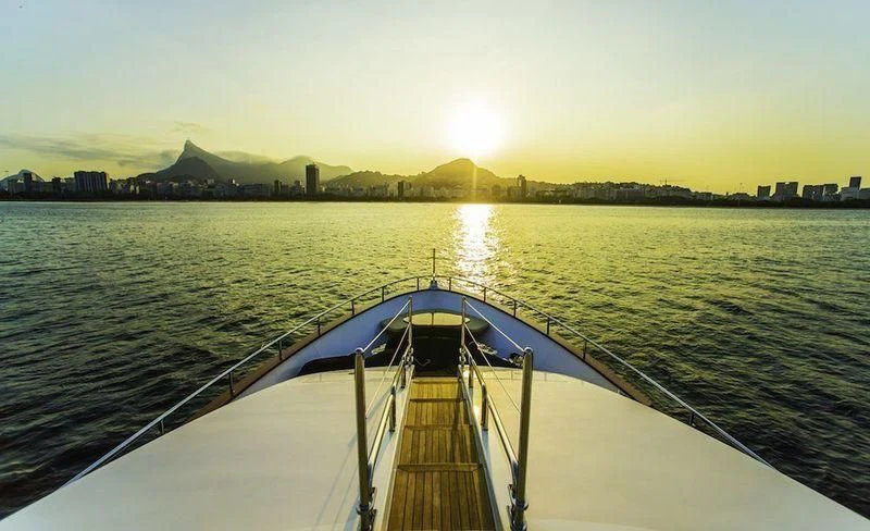 a long boat on a body of water aboard BLUE BAY Yacht for Sale