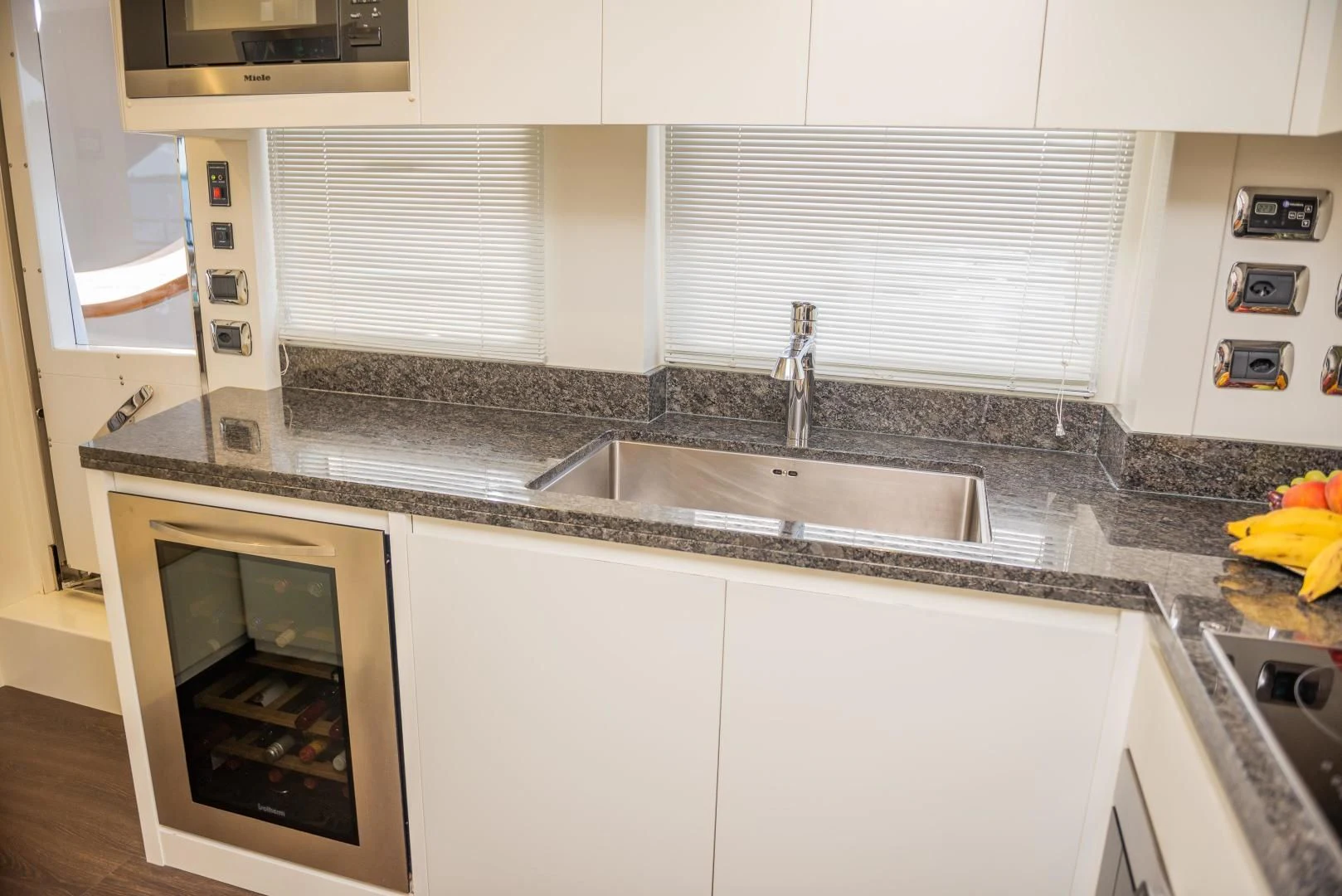 a kitchen with white cabinets aboard BLUE BAY Yacht for Sale