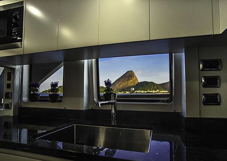 a large kitchen with a large flat screen television aboard BLUE BAY Yacht for Sale