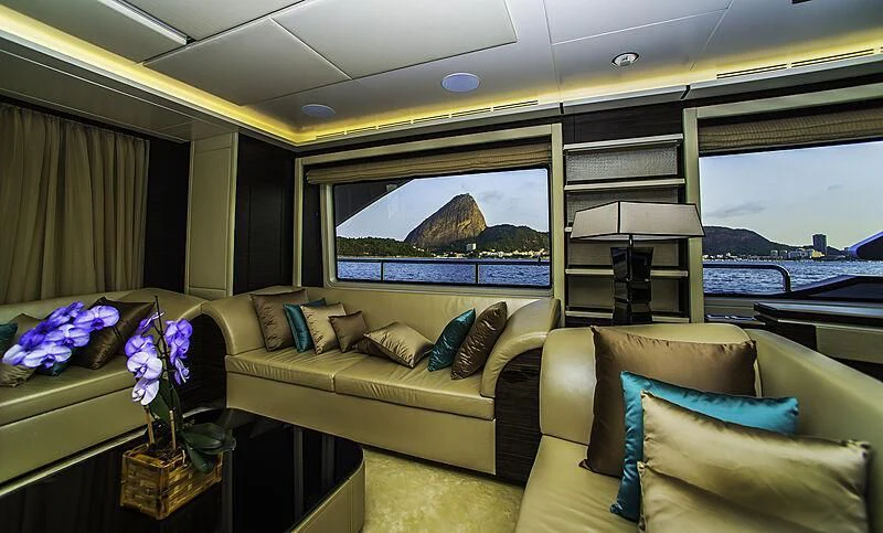 a living room with a large flat screen television and a large window aboard BLUE BAY Yacht for Sale