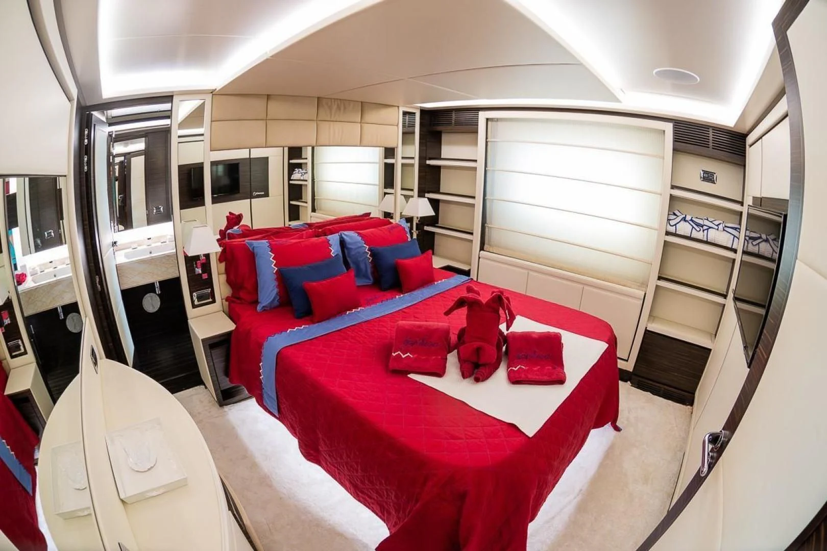 a bedroom with red pillows aboard BLUE BAY Yacht for Sale
