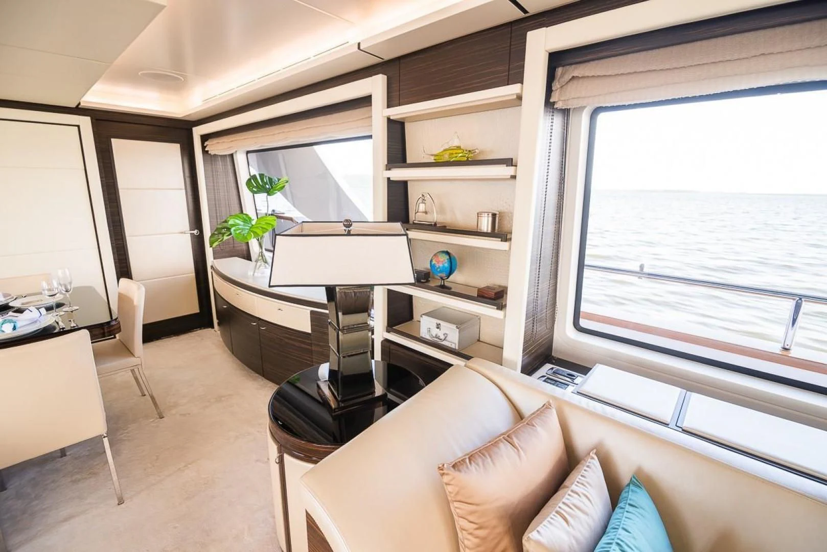 a living room with a piano and a window aboard BLUE BAY Yacht for Sale