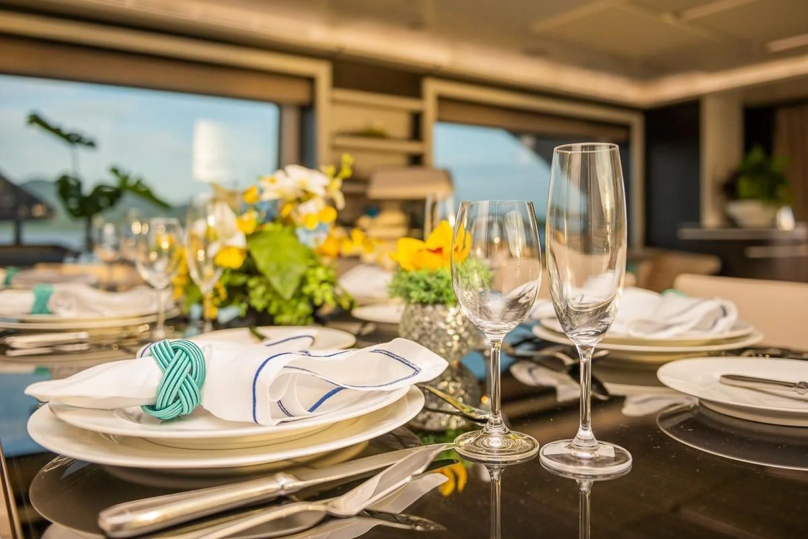 a table with plates and glasses aboard BLUE BAY Yacht for Sale