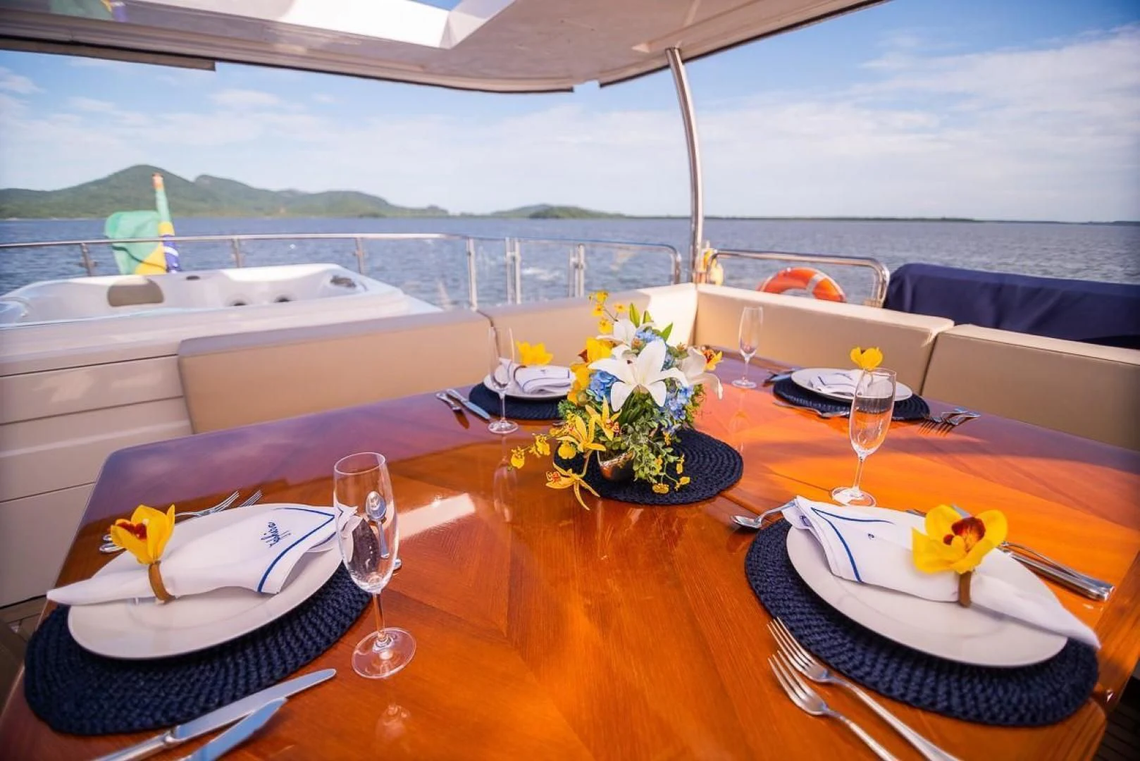 a table with plates and glasses on it aboard BLUE BAY Yacht for Sale