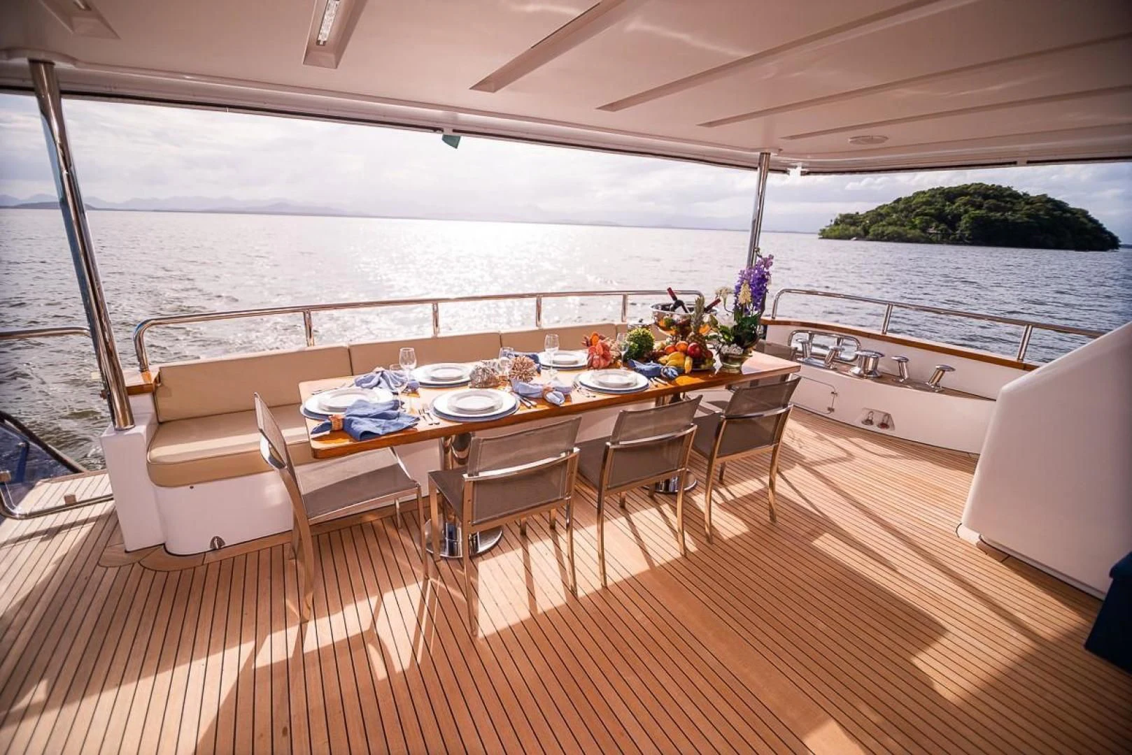a table set for a meal on a deck aboard BLUE BAY Yacht for Sale