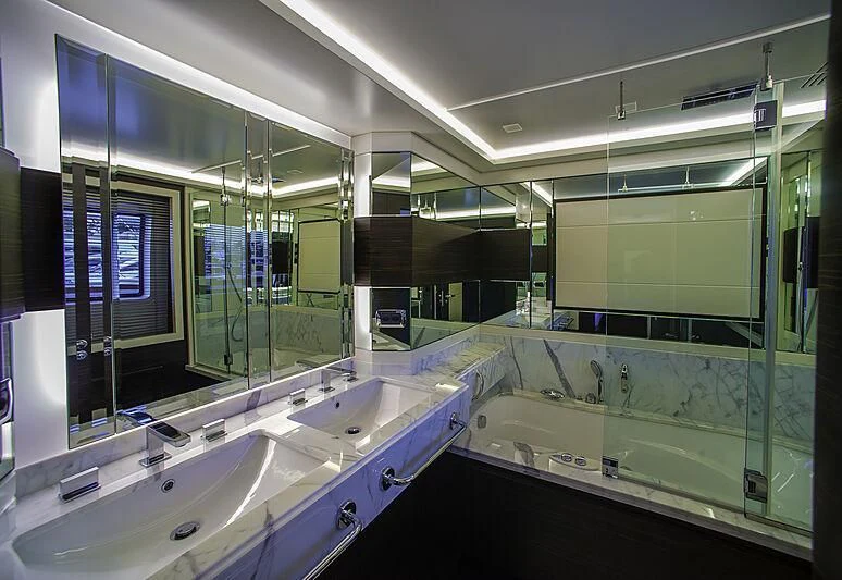 a bathroom with a large mirror aboard BLUE BAY Yacht for Sale