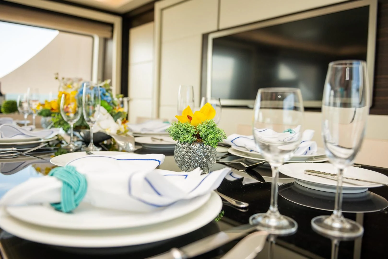 a table with plates and glasses aboard BLUE BAY Yacht for Sale