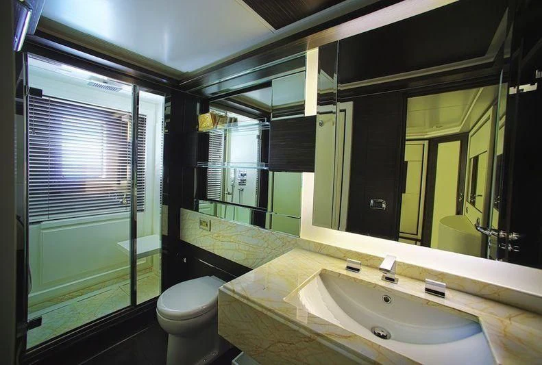 a bathroom with a large mirror aboard BLUE BAY Yacht for Sale