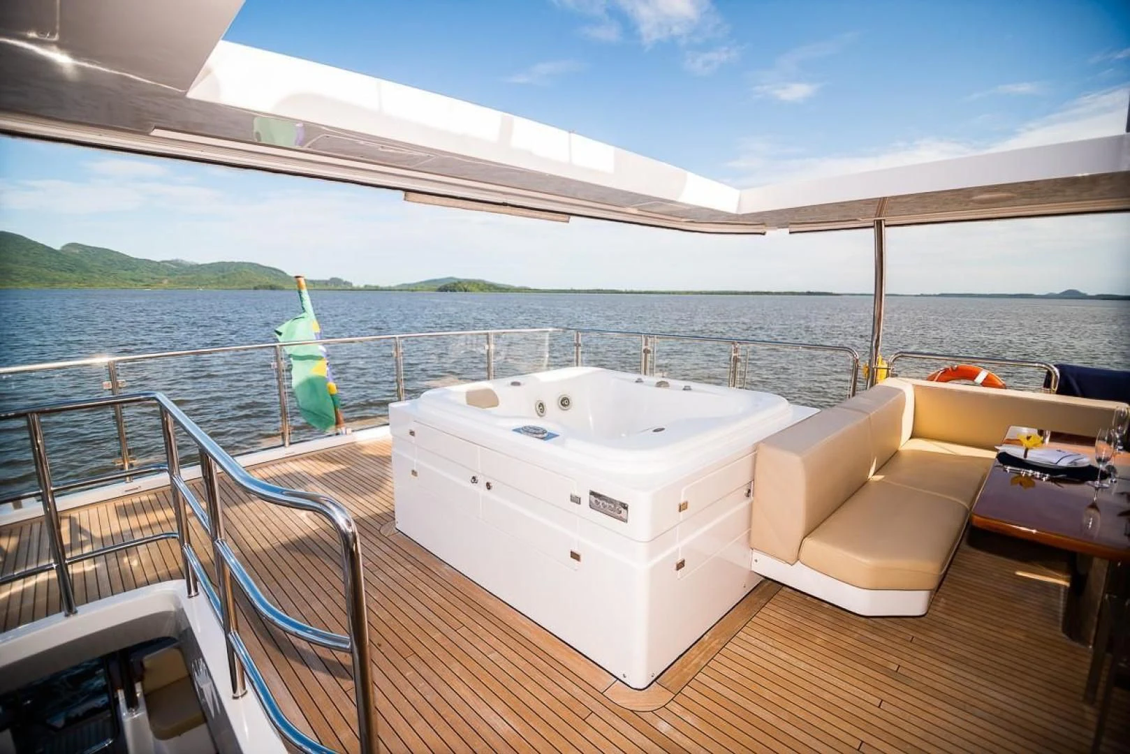 a large white bathtub on a deck overlooking a body of water aboard BLUE BAY Yacht for Sale