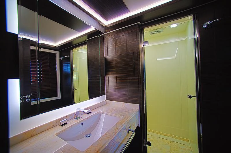 a bathroom with a sink and a mirror aboard BLUE BAY Yacht for Sale