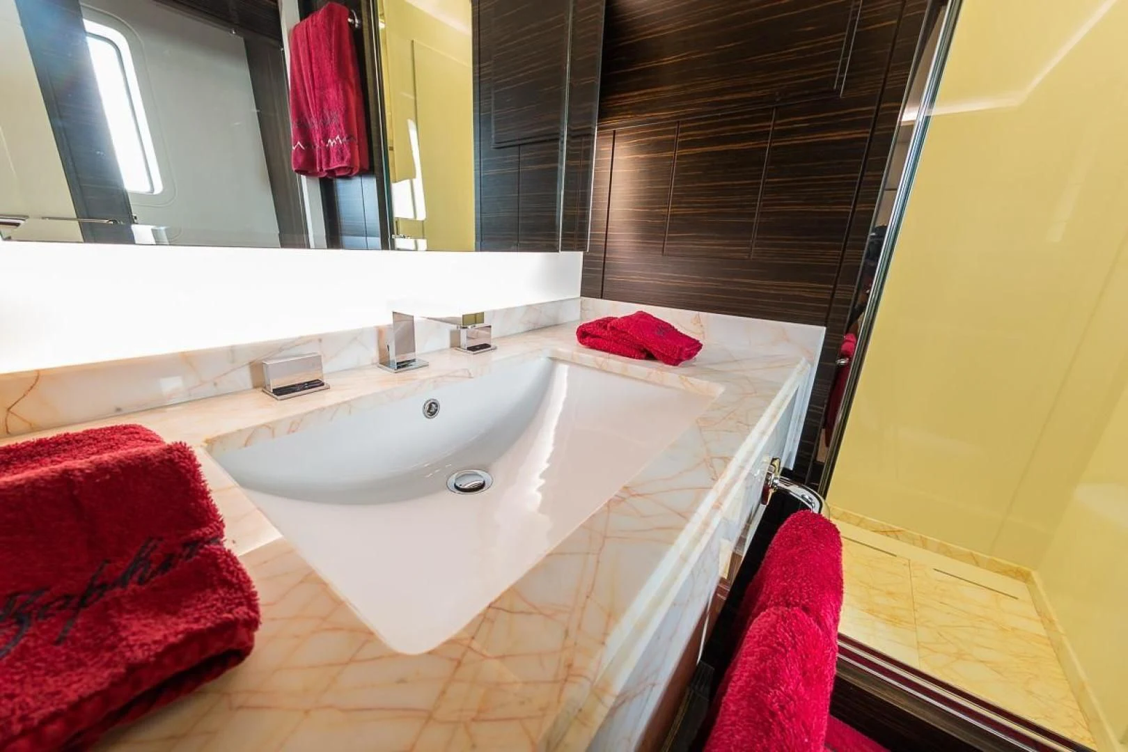 a bathroom with a sink and a mirror aboard BLUE BAY Yacht for Sale