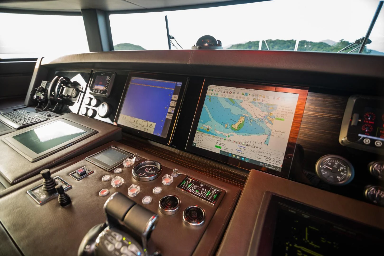 a desk with a laptop and electronic equipment on it aboard BLUE BAY Yacht for Sale