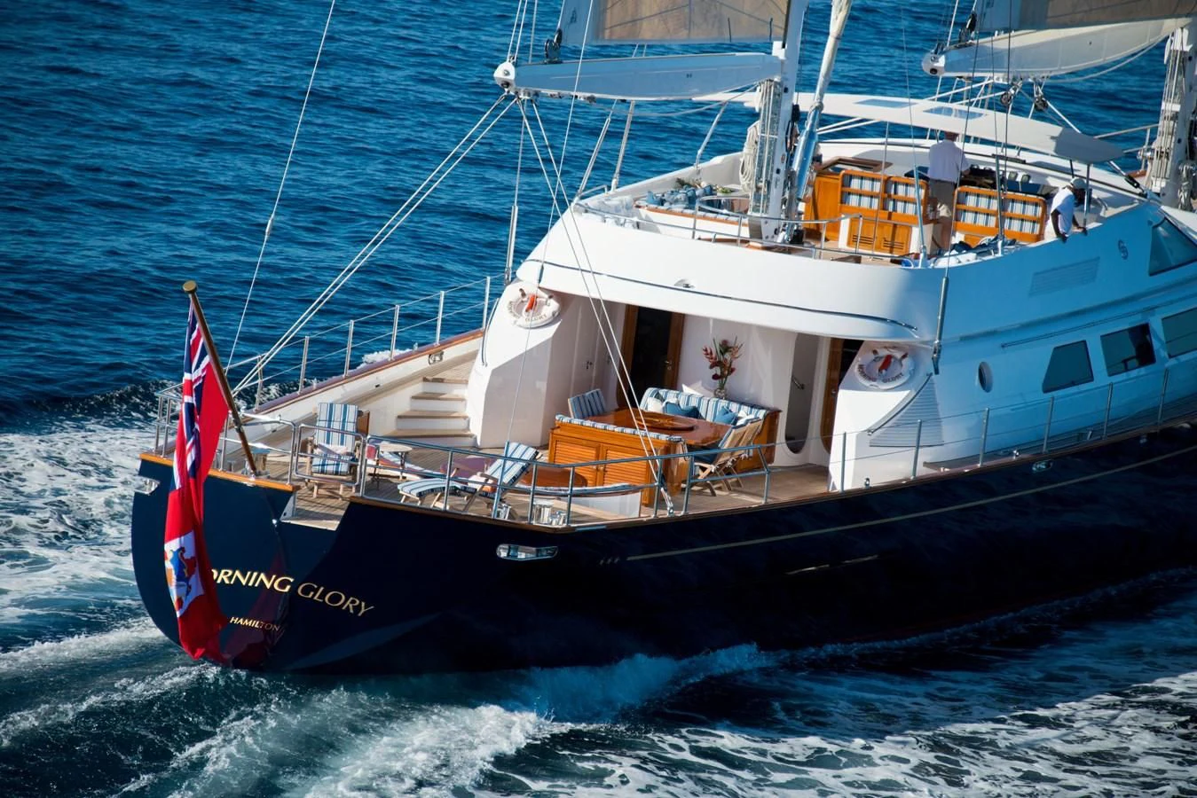 a boat with a red and white stripe on the front aboard MORNING GLORY Yacht for Sale