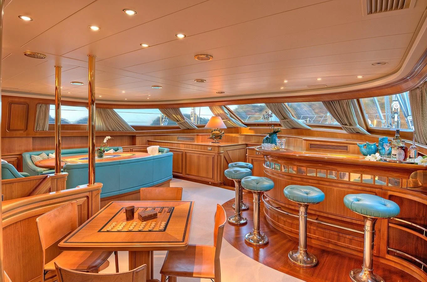 a room with tables and stools aboard MORNING GLORY Yacht for Sale