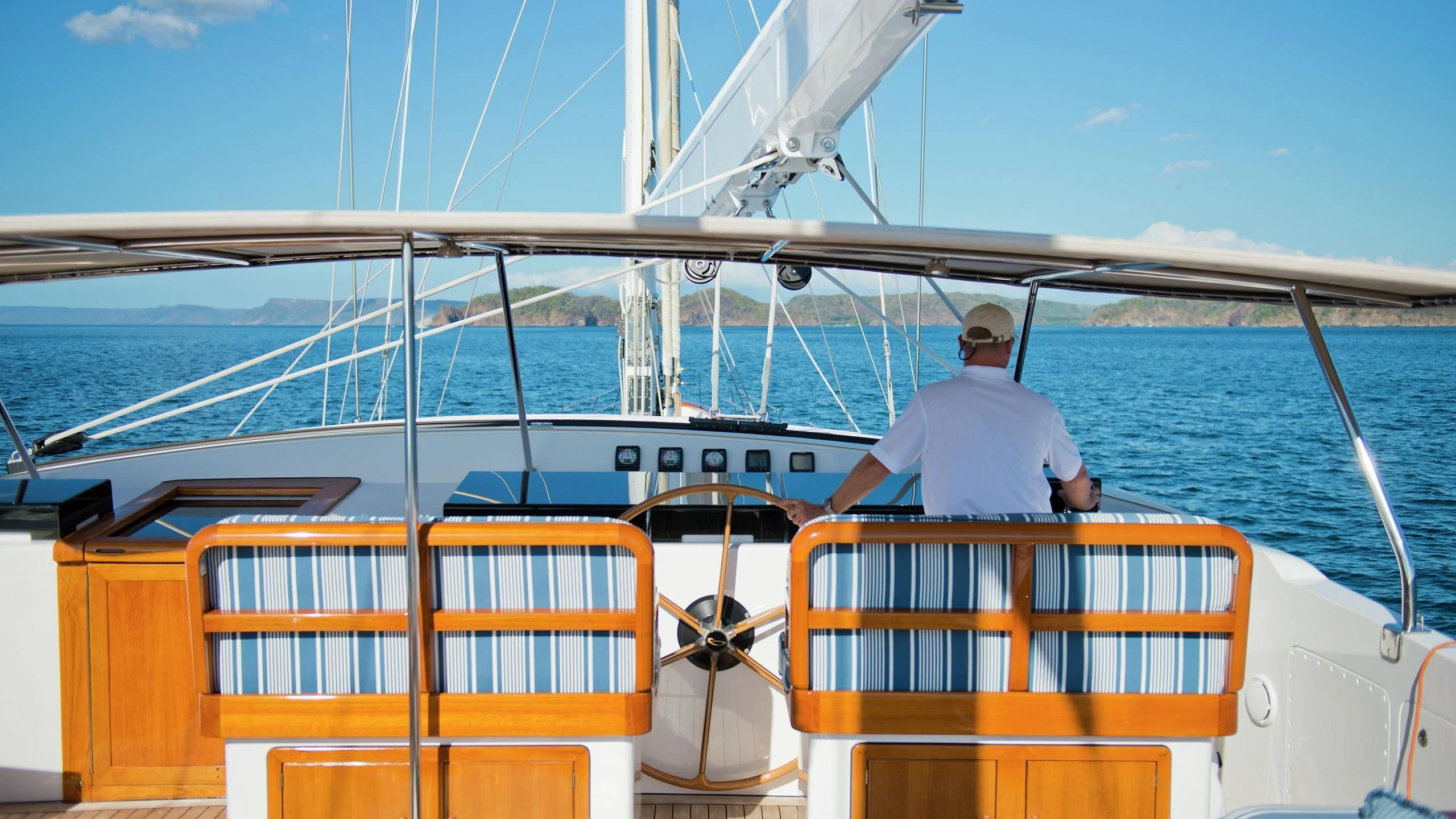 a person standing on the deck of a boat aboard MORNING GLORY Yacht for Sale