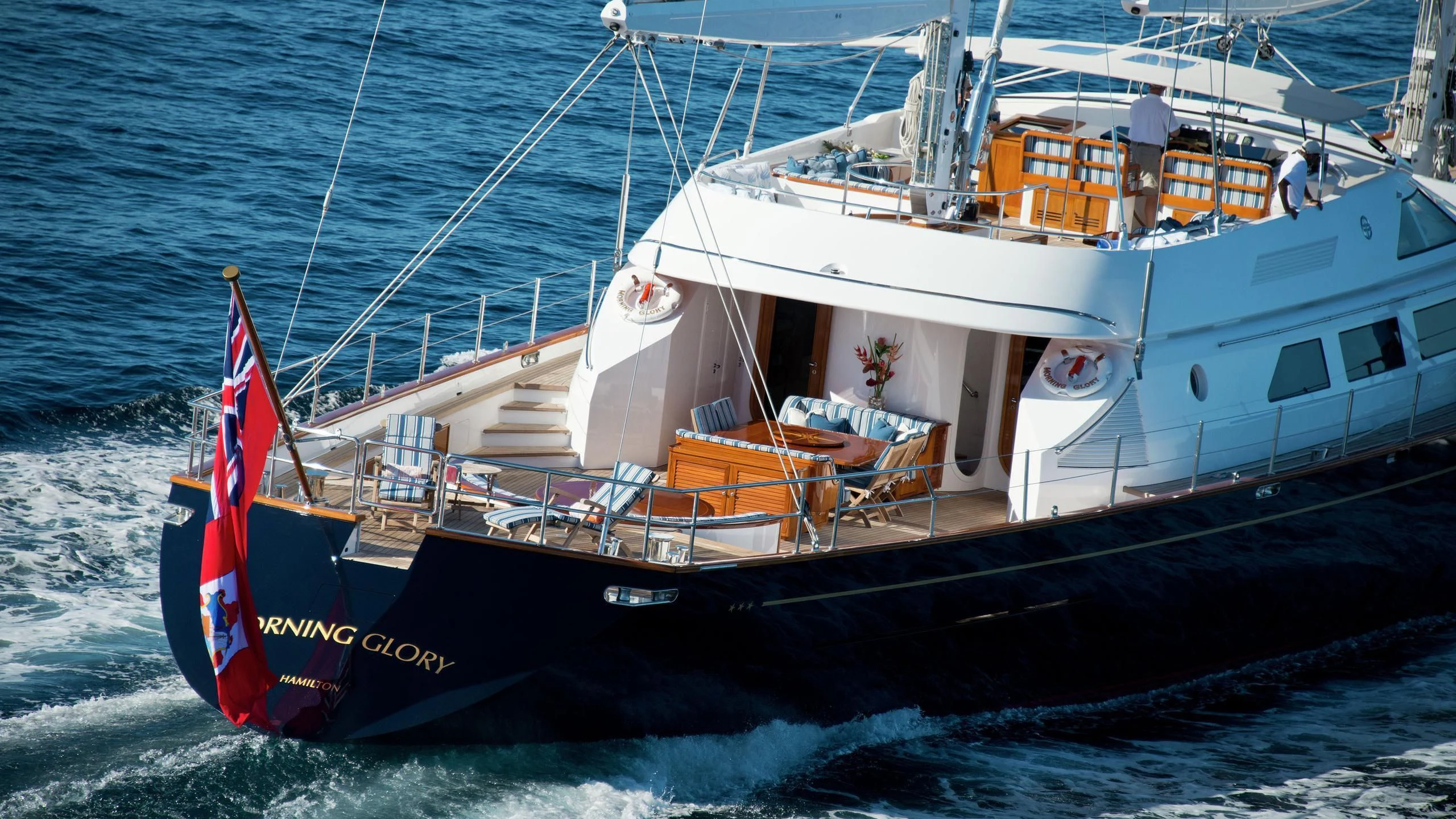 a boat with a flag on it aboard MORNING GLORY Yacht for Sale