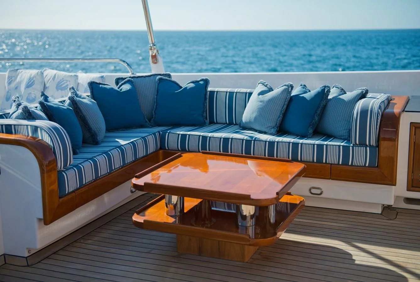 a couch with a table on it aboard MORNING GLORY Yacht for Sale