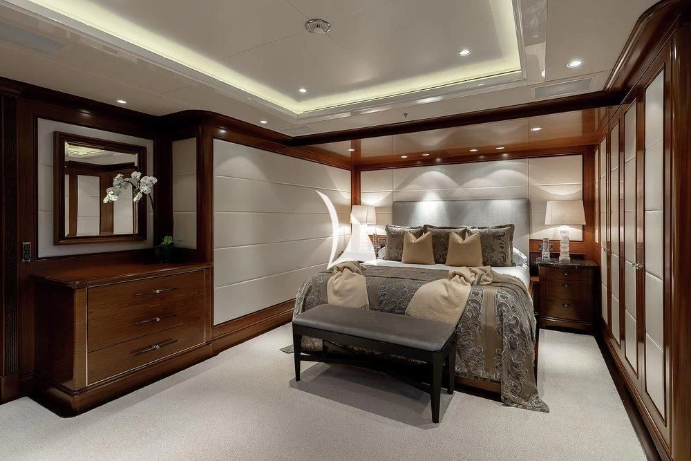 a bedroom with a bed and a mirror aboard SEANNA Yacht for Sale