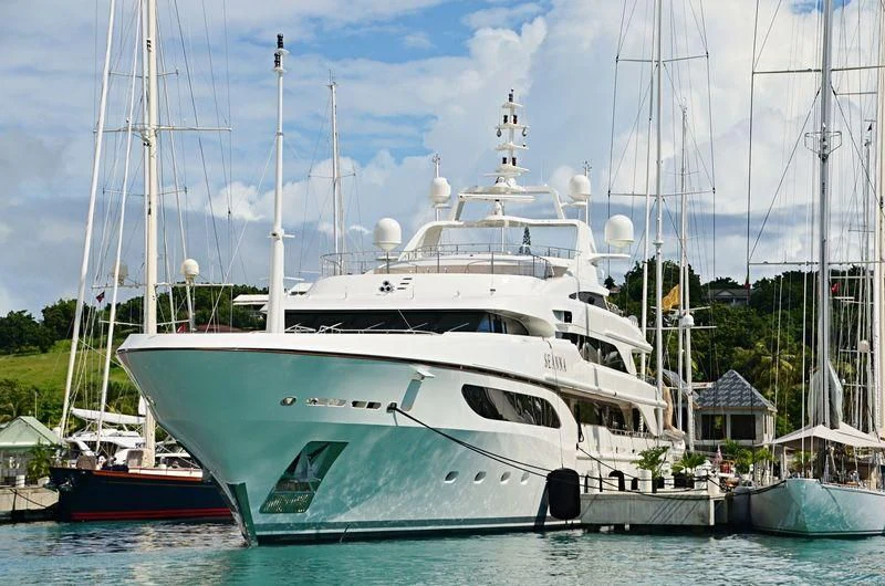 a large white boat in a harbor aboard SEANNA Yacht for Sale