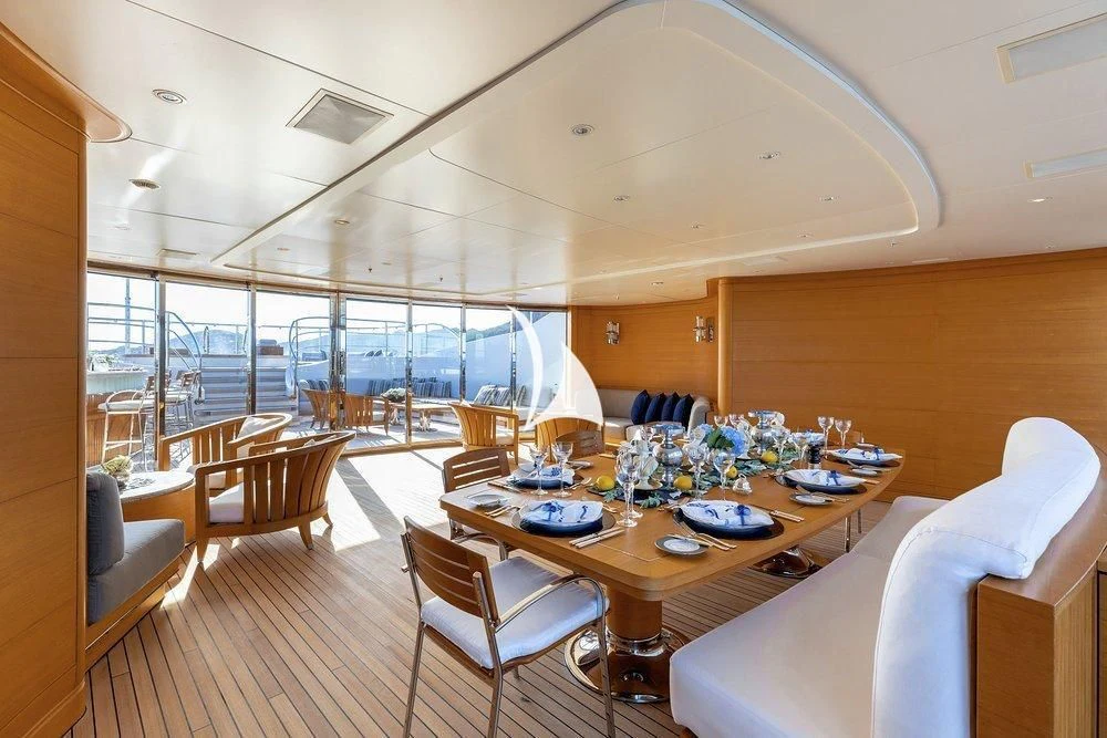 a large room with a table and chairs aboard SEANNA Yacht for Sale