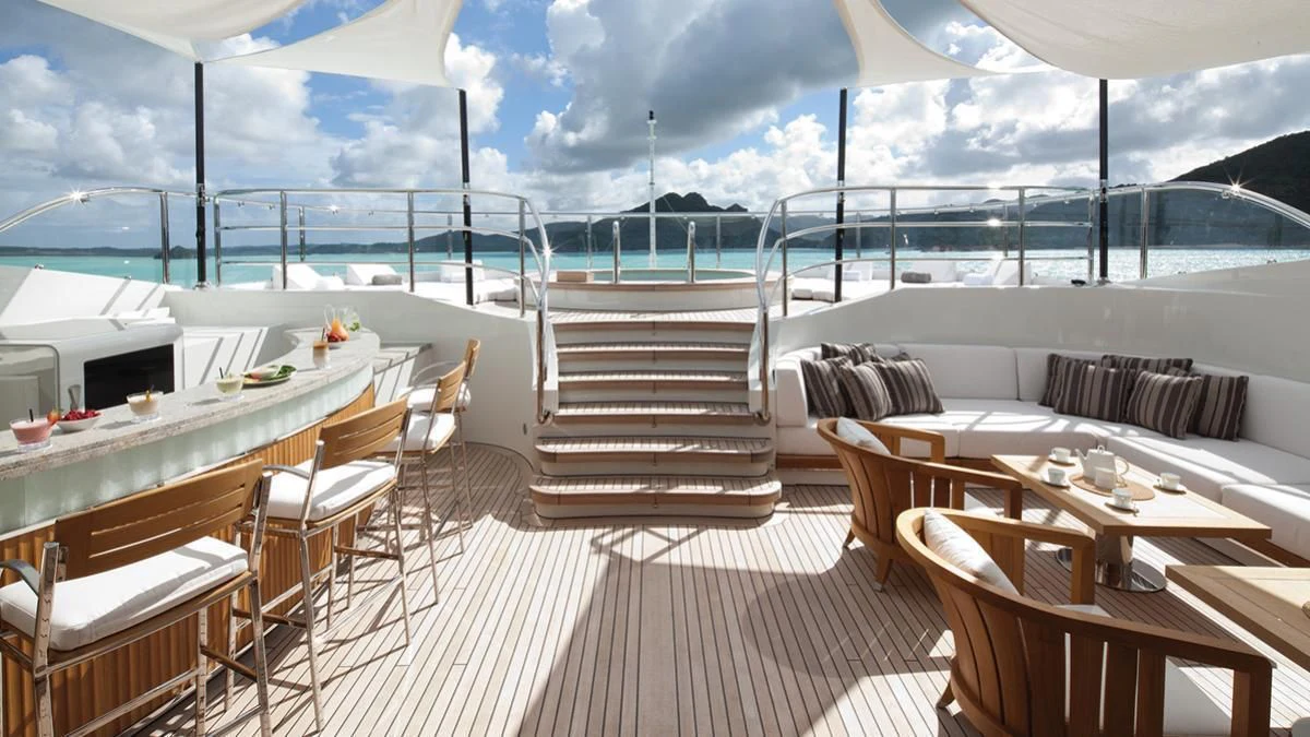a deck with tables and chairs aboard SEANNA Yacht for Sale
