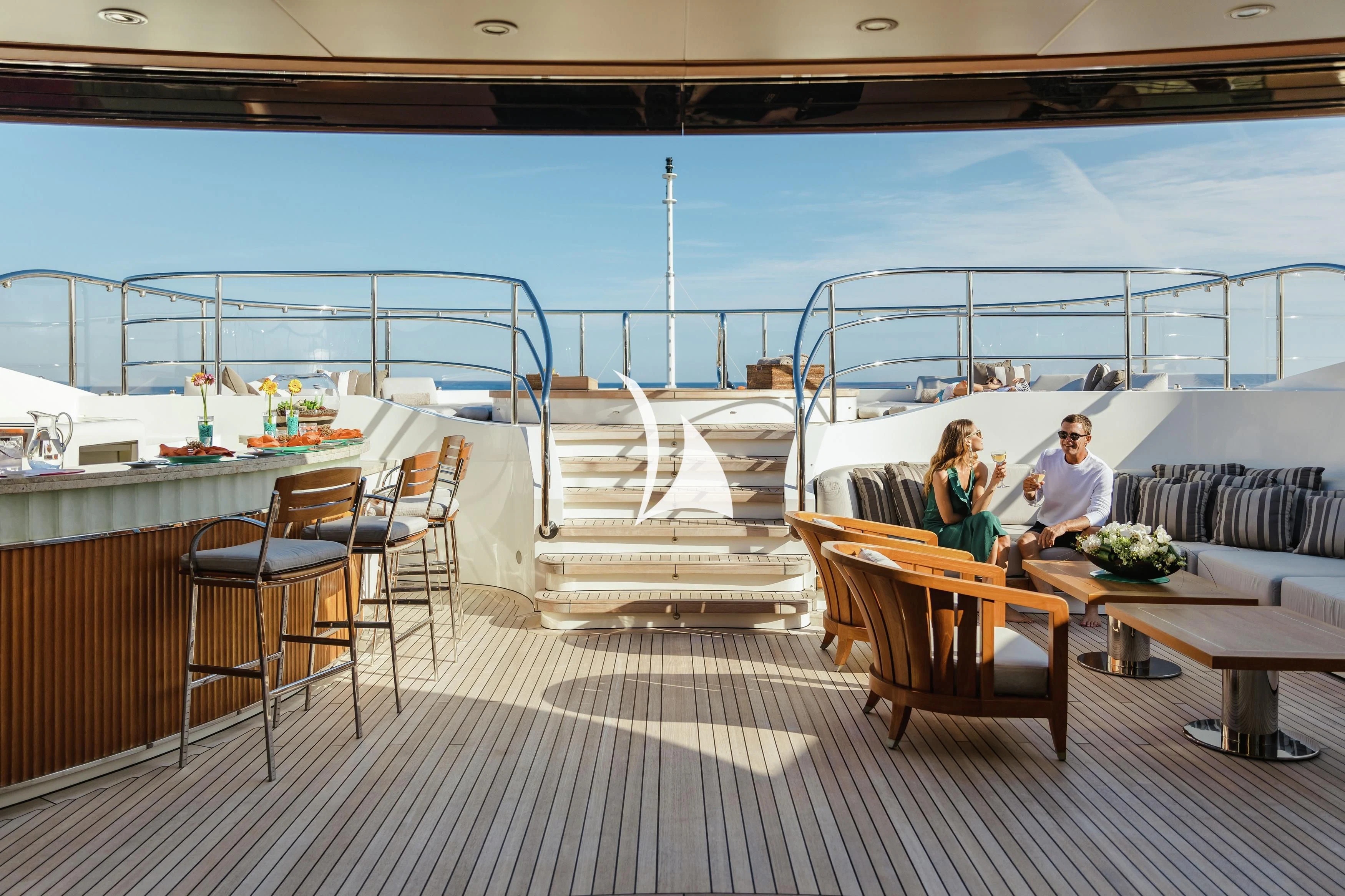 a group of people sitting on a deck on a boat aboard SEANNA Yacht for Sale