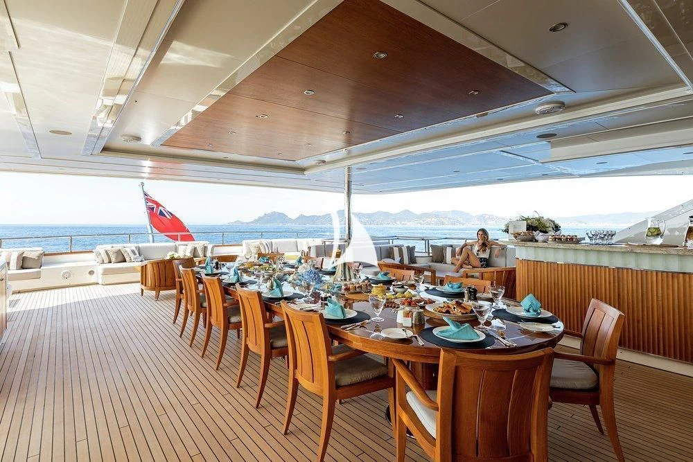 a restaurant with tables and chairs aboard SEANNA Yacht for Sale