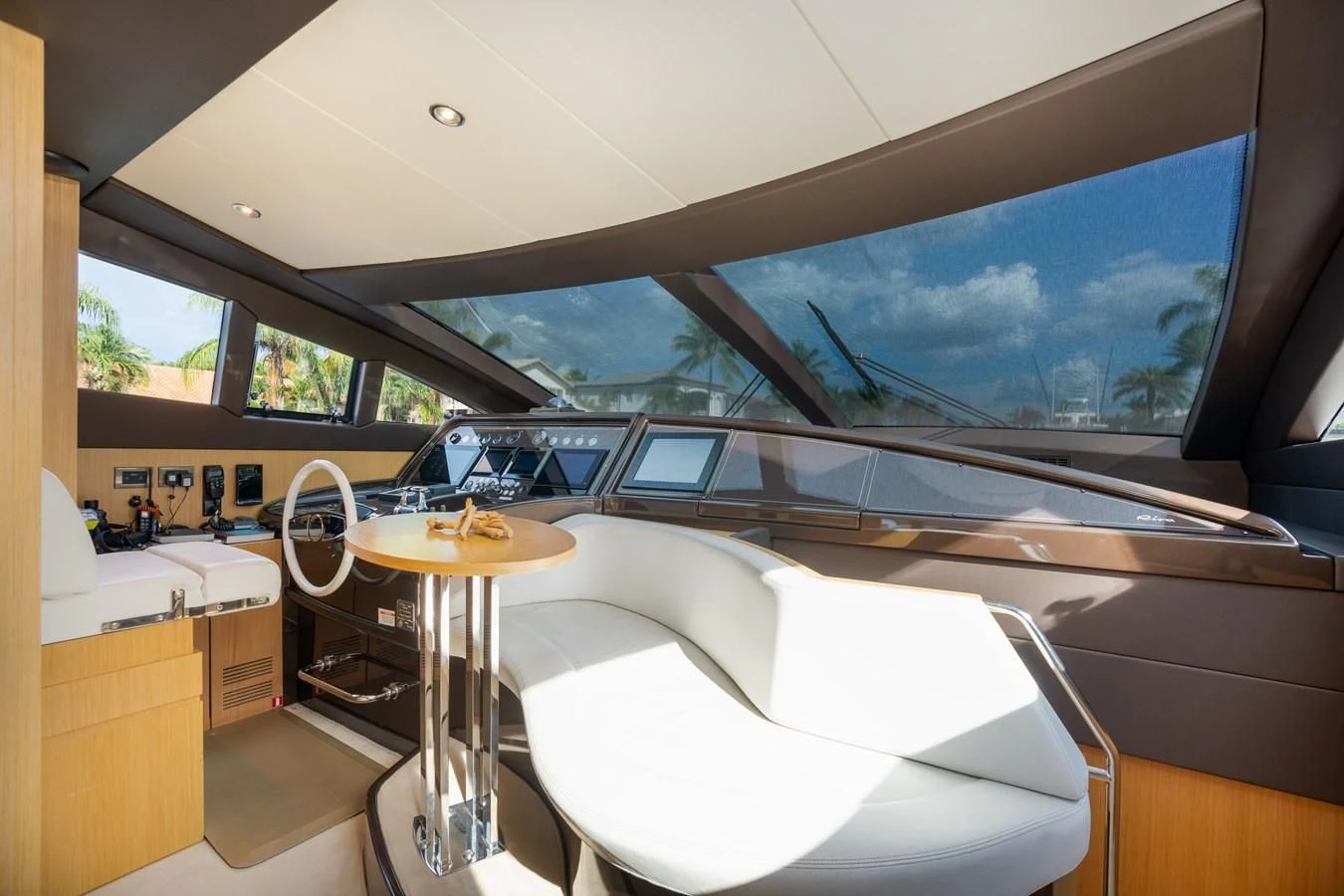 a room with a table and a window with a view of mountains aboard 75' RIVA 2012 Yacht for Sale