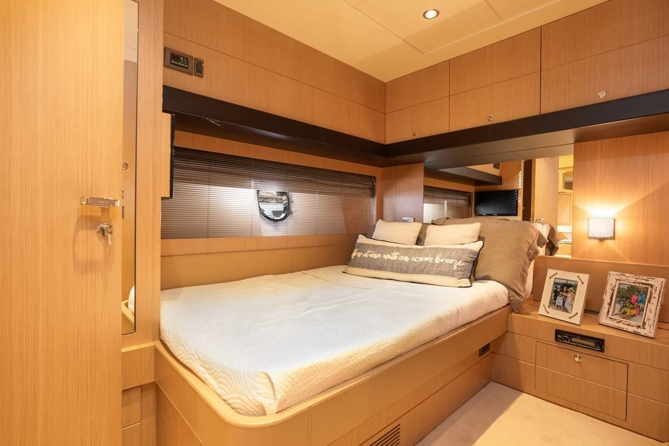 a room with a bed and a wood cabinet aboard 75' RIVA 2012 Yacht for Sale