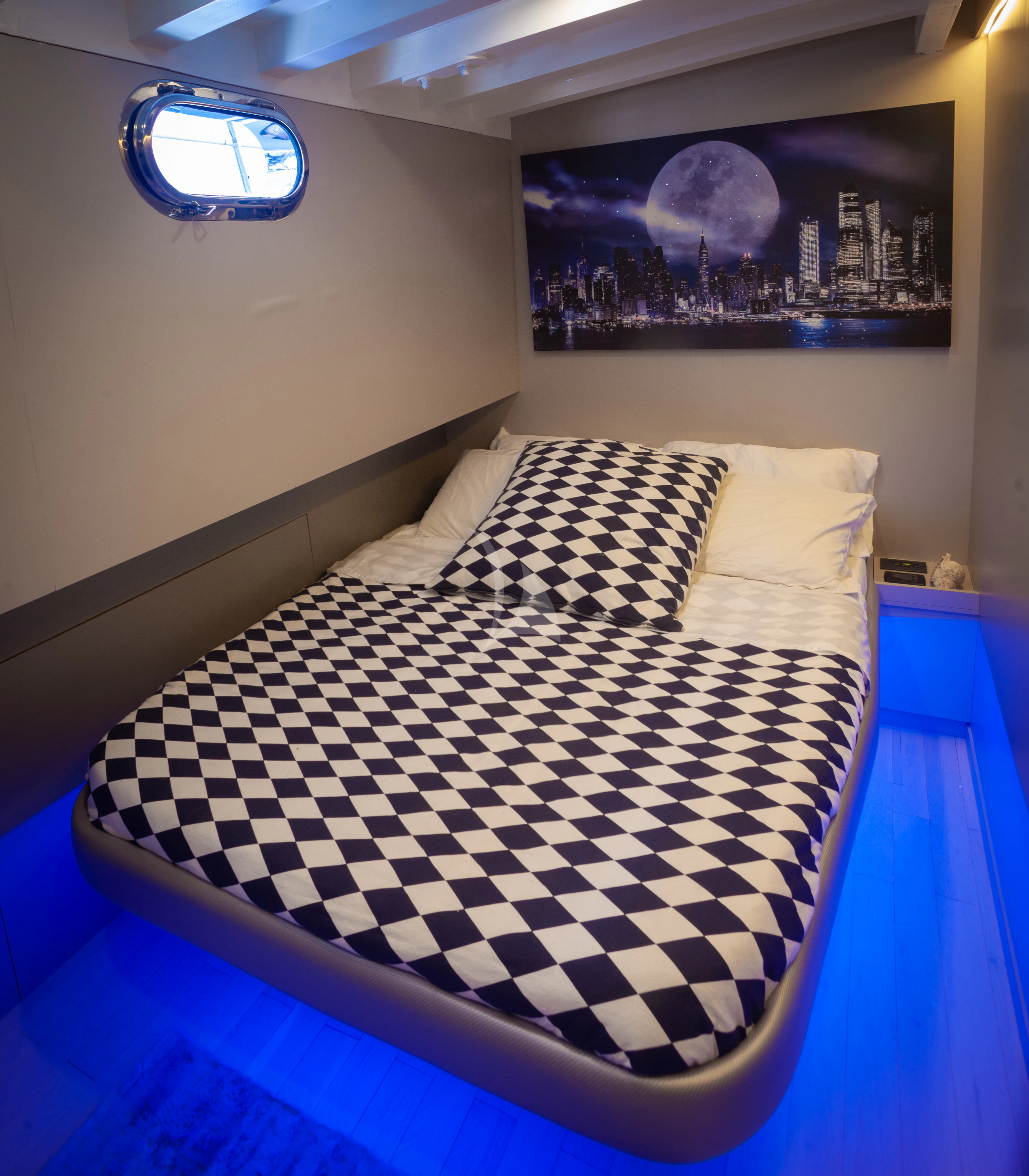 a bed with a checkered blanket aboard LA MER Yacht for Sale