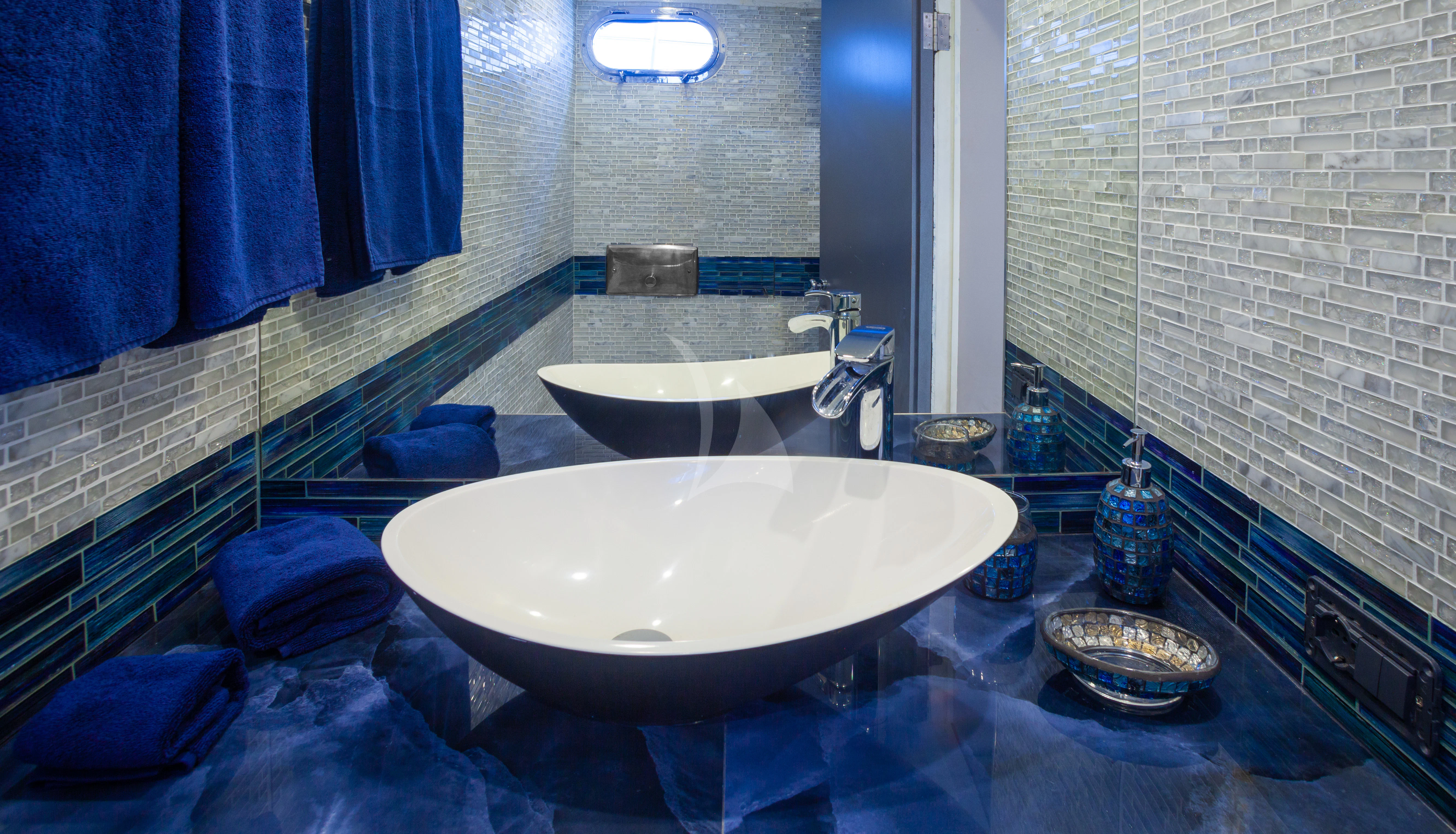 a bathroom with a large blue tub aboard LA MER Yacht for Sale
